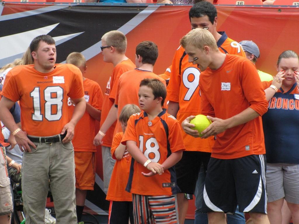 NSCD athletes receive some last-minute coaching before hitting the field at the Denver Broncos Football Ability Clinic. Credit.