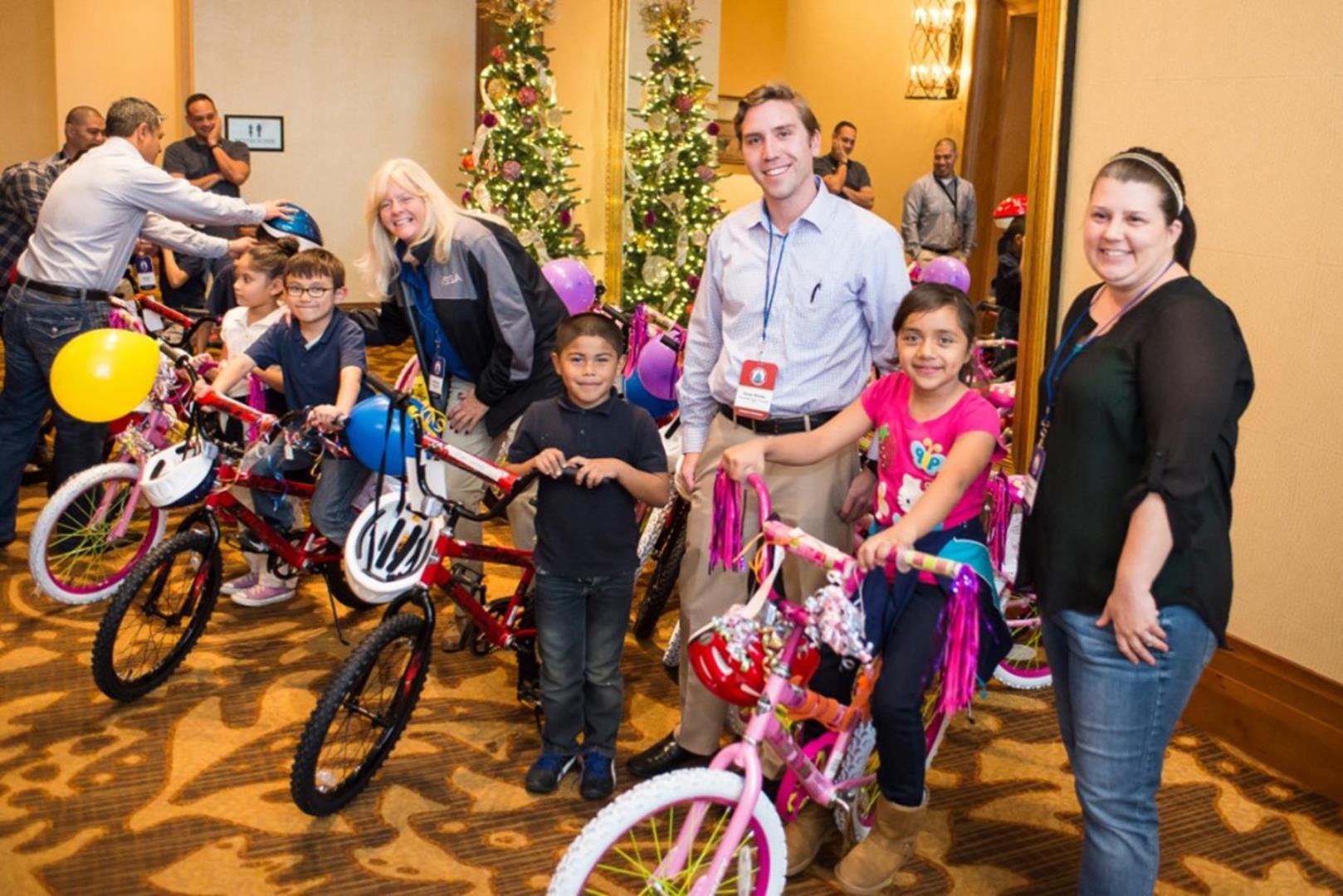 Parker Medley from Marco Island/Naples Sports helps kids choose a bike.