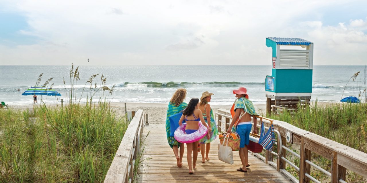 A Carolina beach family on the boardwalk. Photo courtesy of Wilmington and Beaches CVB