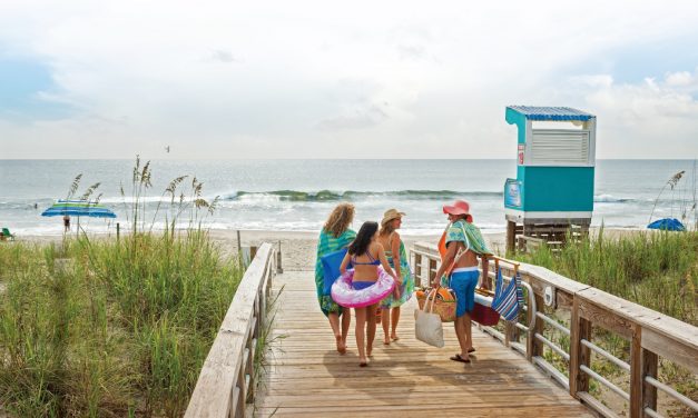 A Carolina beach family on the boardwalk. Photo courtesy of Wilmington and Beaches CVB