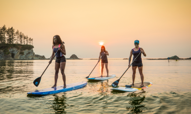Paddleboarding on calm waters at Sunset Bay State Park