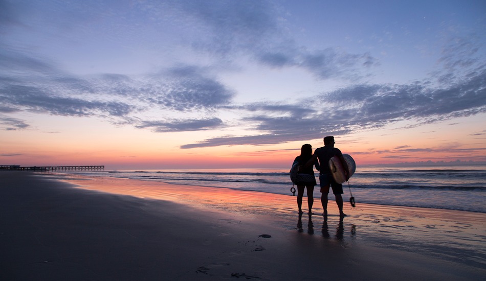 Wrightsville-Beach-Surfer-silhouettes-Along-Shoreline-at-Sunrise