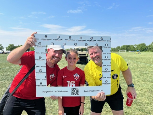 Coach, player and referee in the same frame, on the same team.