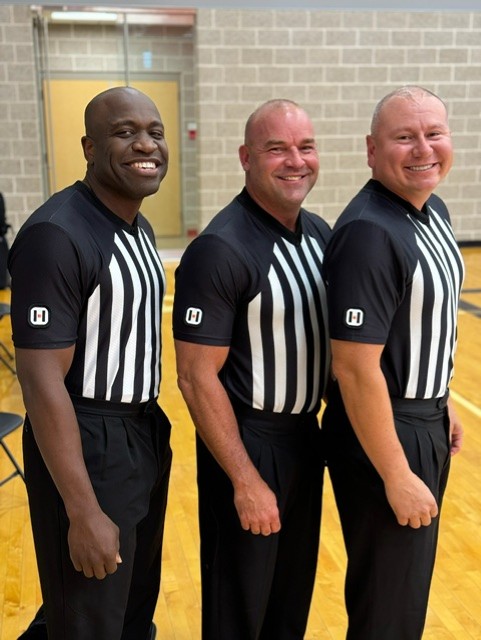 Officials posing before tip off.