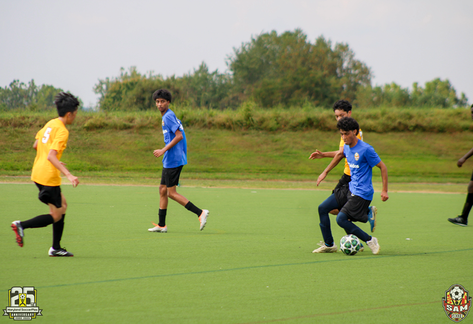 A youth player moves the ball